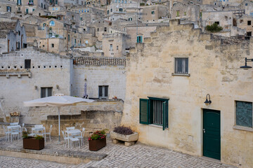 Fototapeta premium Charming streets of Matera in Puglia, Italy showcase ancient architecture and serene outdoor dining