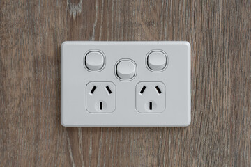 Close-Up of Electrical Power Outlet on Wood Wall