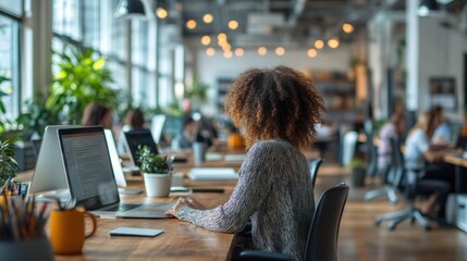 Modern office space with people working and plants.