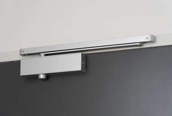 Closeup of an automatic door closer.