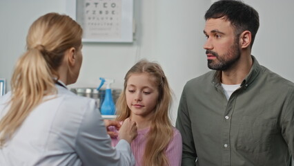 Practitioner checking kid health in hospital closeup. Woman doctor talk father