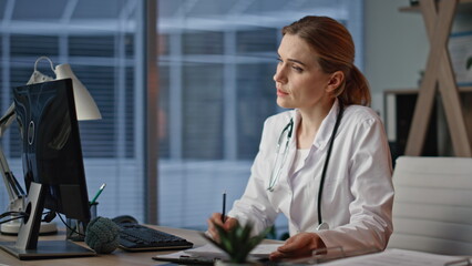 Practitioner examining patient online at desk closeup. Doctor talking video call