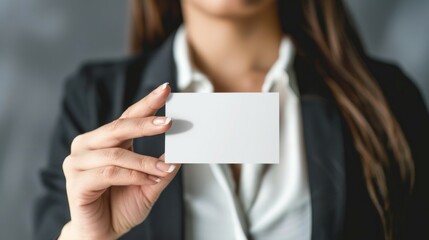 Businesswoman holding blank card. A businesswoman presents a blank card, symbolizing opportunity and professional growth.