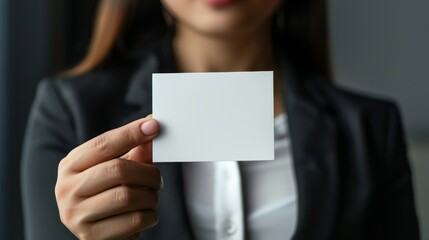 Woman holding blank card. A businesswoman holds a blank card, representing opportunity, new beginnings, and a blank canvas for potential.