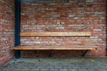 The interior of a street bus stop. There are red brick walls, a wooden bench. Small trash and...