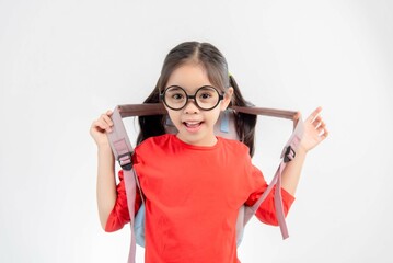 A child asia girl with a school backpack and Wear glasses