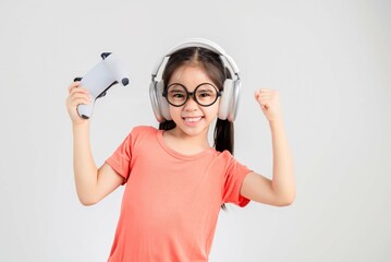 Asian happy portrait young kid girl smile lifestyle games technology holding joystick game playing on hands studio shot isolated white background with copy space.