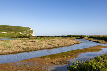 The Cuckmere River with Haven Brow behind, on a sunny spring day