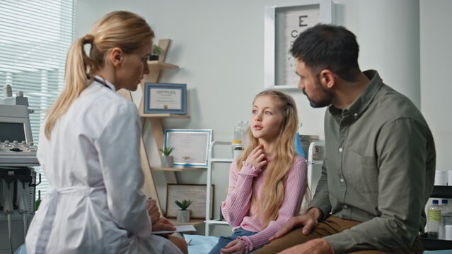 Ill child complaining practitioner about health problem. Professional doctor