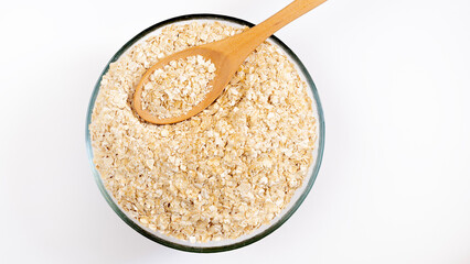 Oat flakes pile, cereal for breakfast isolated on white, top view