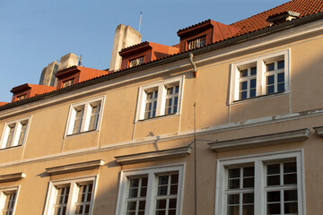 The charming facade of a classic style residential building shines beautifully under the warm sunlight
