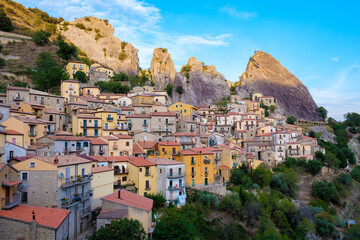 A breathtaking view of Castelmezzano, Italy, nestled among stunning rocky landscapes at sunset