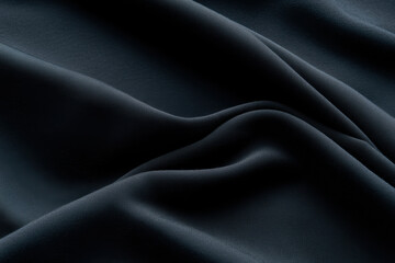 Obraz premium Soft black fabric with smooth texture and gentle wrinkles creates elegant appearance, perfect for various fashion and design applications