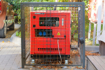 Outdoor diesel power generator. Power supply generator placed on street sidewalk. Small business...