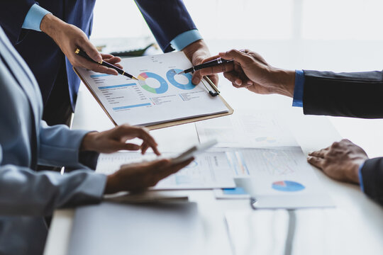Meeting of business executives discussing analysis of the company's financial situation and business planning with partner collaboration and consultation of strategy.