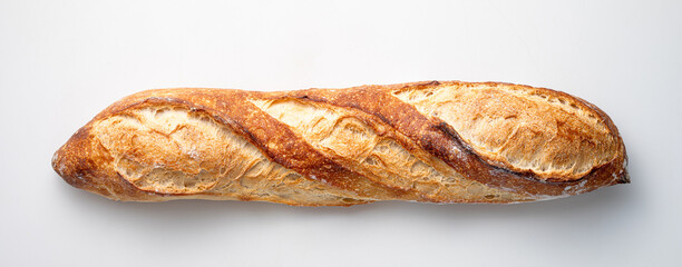 A long, freshly baked baguette with a crispy golden crust rests on a smooth white surface, showcasing its artisanal craftsmanship and texture.