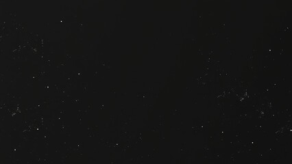 Dark background with white specks.