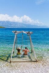 Enjoying a sunny day on Brac Island with swings by the crystal-clear Adriatic Sea