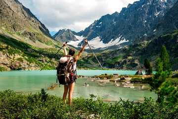 a tourist girl with a backpack on Lake Kuyguk in Altai