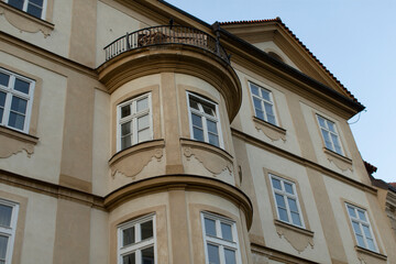 The building features a gracefully curved balcony and an exquisitely ornate facade, representing timeless architecture