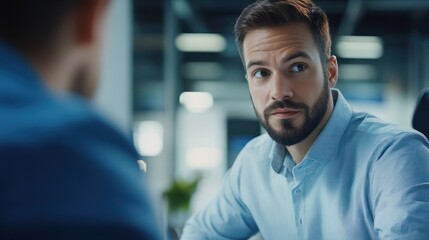 Obraz premium Male engineer looking at coworker while discussing in industry