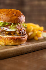 A classic burger served with a side of fries and dipping sauce, showcasing a delicious and...