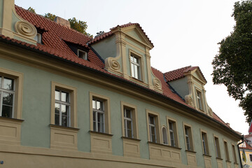 An intricately designed historical building that showcases stunning windows and a vibrant, colorful roof