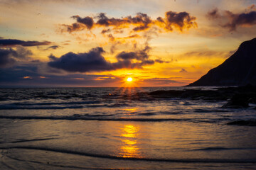 Colorful dramatic golden midnight sun in arctic region of Lofoten with dramatic sunset over the...