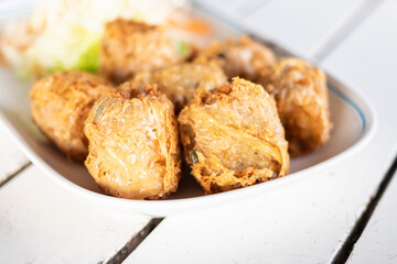 Crispy fried crab spring rolls. A delicious plate of golden fried snacks.