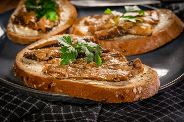 Slices of multigrain bread with sprats.