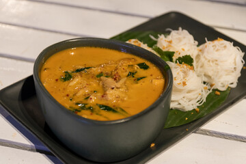 Crab and betel leaf curry. Thai Southern-style crab yellow curry with betel leaves and garlic rice noodles.