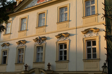 The stunning facade of an old building is showcasing intricate designs along with beautiful windows throughout