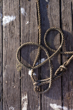 coiled rope on wooden jetty planks