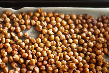 Sheet pan with homemade roasted chickpeas. Selective focus.