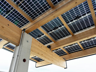 Solar panels roof for parking lot, electric cars parking with integrated charging station, view...