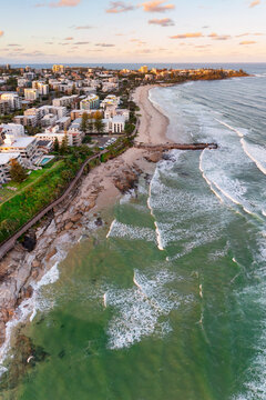 Aerial view over a coastal city with highrise buildings at dusk