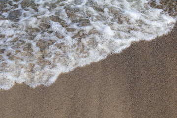 Gentle Ocean Waves Washing Over Sandy Beach