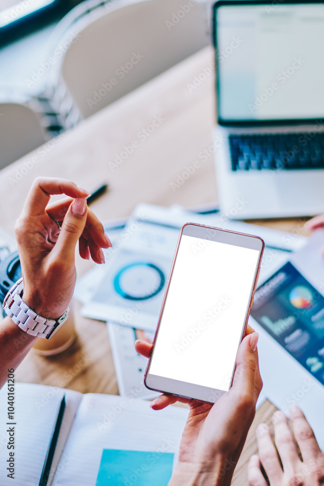 Poster cropped view of hand holding modern smartphone with blank screen area for your internet content on b