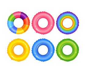 Colorful inflatable rubber rings floating on water surface