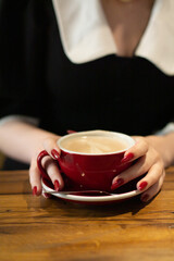 A girl warms up for a cup of coffee