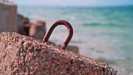 Fototapeta premium Sea Waves Hitting Shore with Splashing on Heavy Concrete Tetrapod Coastal Defense Structure Seawall Embankment