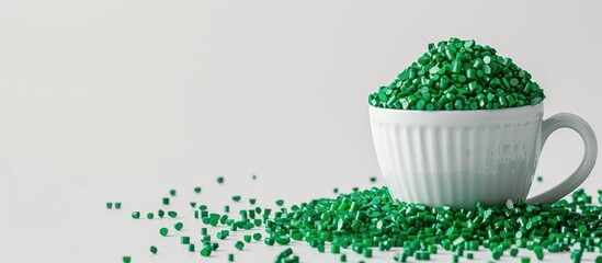 Fototapeta premium Pine green masterbatch granules displayed in a cup on a white background suitable for a copy space image in the plastic industry