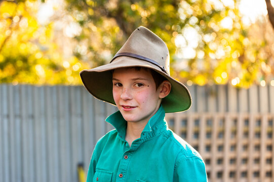 POrtrait of young australian boy wearing green button up and akubra hat