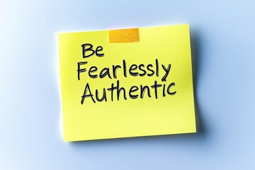 A yellow sticky note with a handwritten message - Be Fearlessly Authentic - serving as a motivational reminder to embrace and express one’s genuine self.