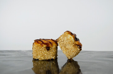 Baked sushi roll with cheese top.