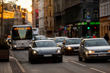 Cars of transport in city centre during heavy traffic hours in Riga Latvia during sun and shadows...