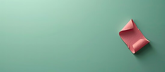 Pink paper with green background displaying a symbolic career advancement message featuring copy space image