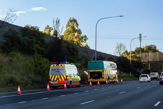 Traffic emergency patrol vehicle stopped beside broken down bus beside highway