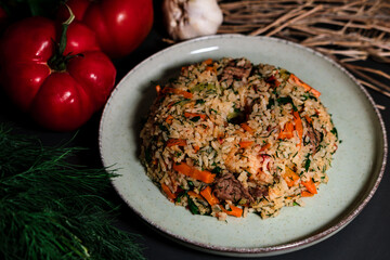 Spanish rice, uzbek pilaf hot dish with meat and vegetables, rustic table kitchen decoration with ingredients