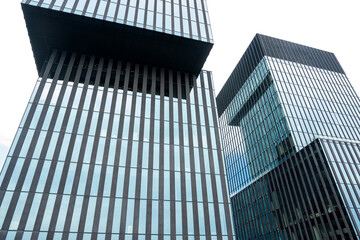 Exterior of modern office building. Glass building skyscrapers over grey cloudy sky